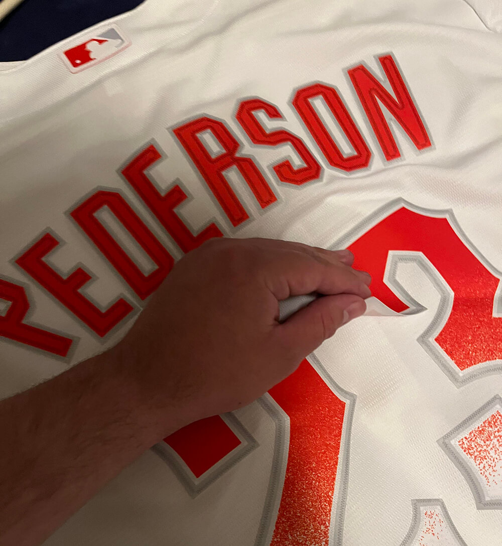A peeling number on a red soccer jersey